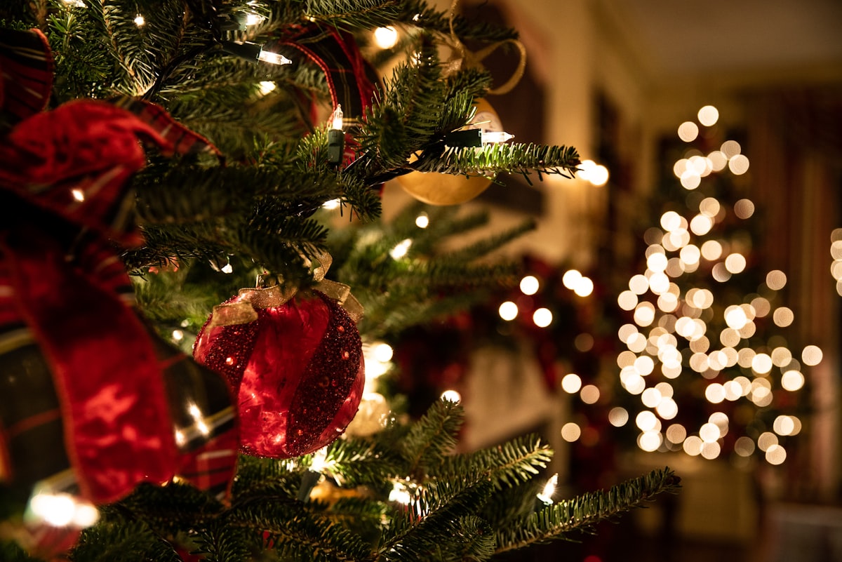 Pessoas dançando em comemoração ao Natal com luzes festivas ao fundo